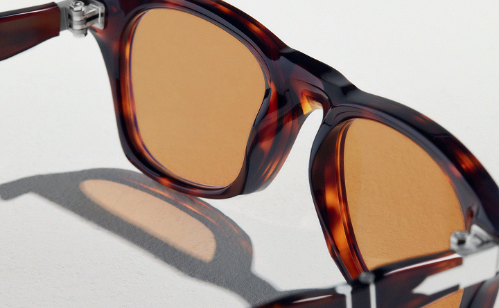 Persol® Eyewear Featuring Barberini® Sunglass Lenses Close-up of Persol® sunglasses with tortoiseshell acetate frame and Barberini® sunglass lenses, showcasing premium craftsmanship and optical quality.